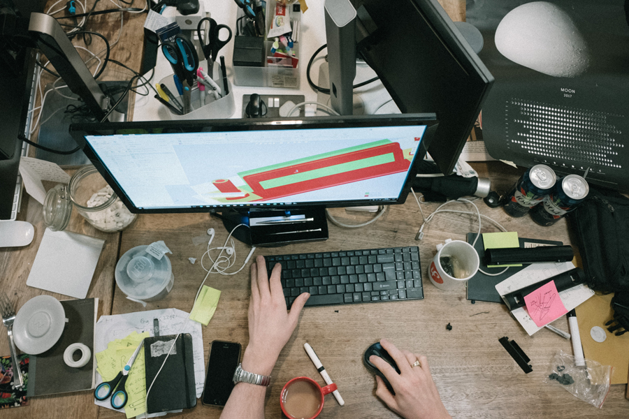 a messy office with piles of paper