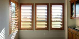 wall of windows with stained wood shutters in San Antonio TX