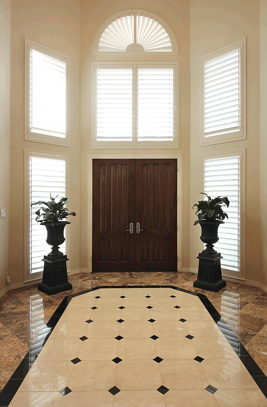 entryway with arched window treatments plantation shutters Central Texas