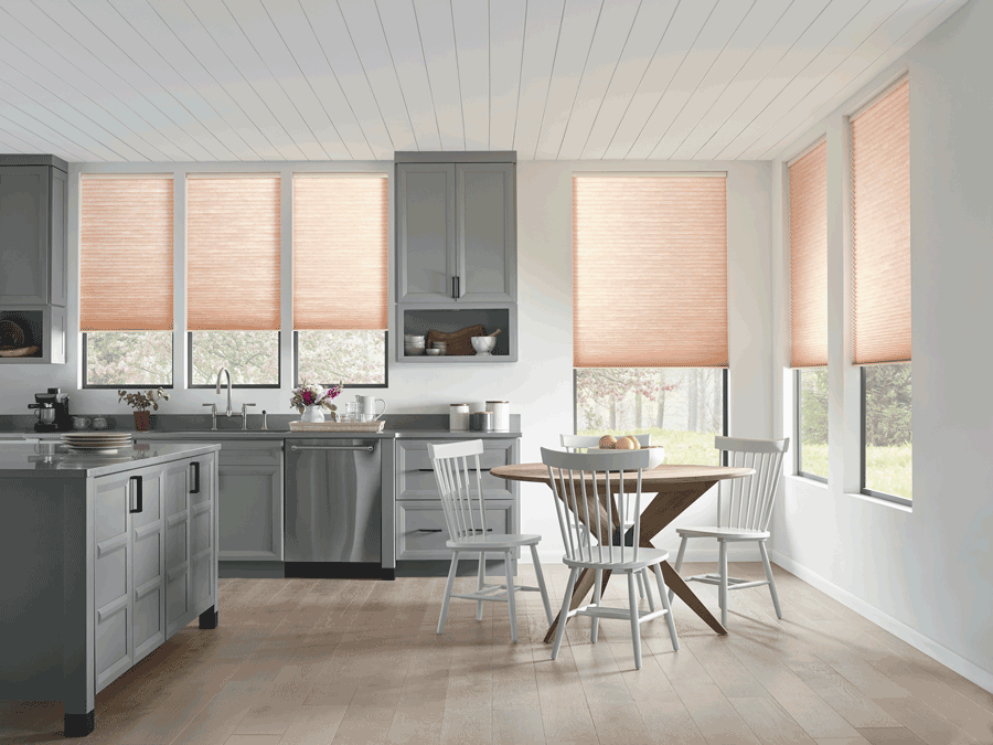 Kitchen with modern taste and motorized shades that are half drawn. Shades are on list of favorite features.