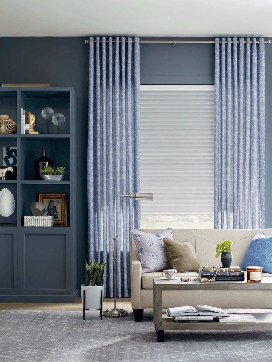 living room with blue draperies to layer window treatments with roller shades San antonio TX