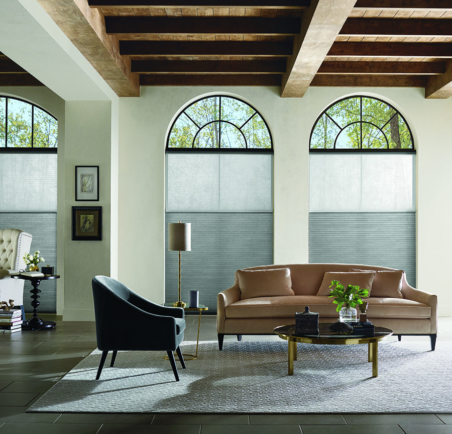 Sitting room with Applause Honeycomb shades on arched windows.