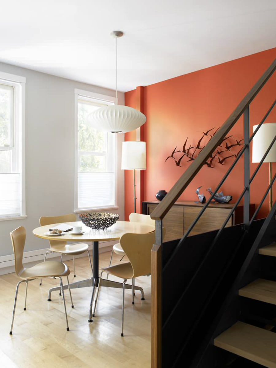 rust orange accent wall in dining room