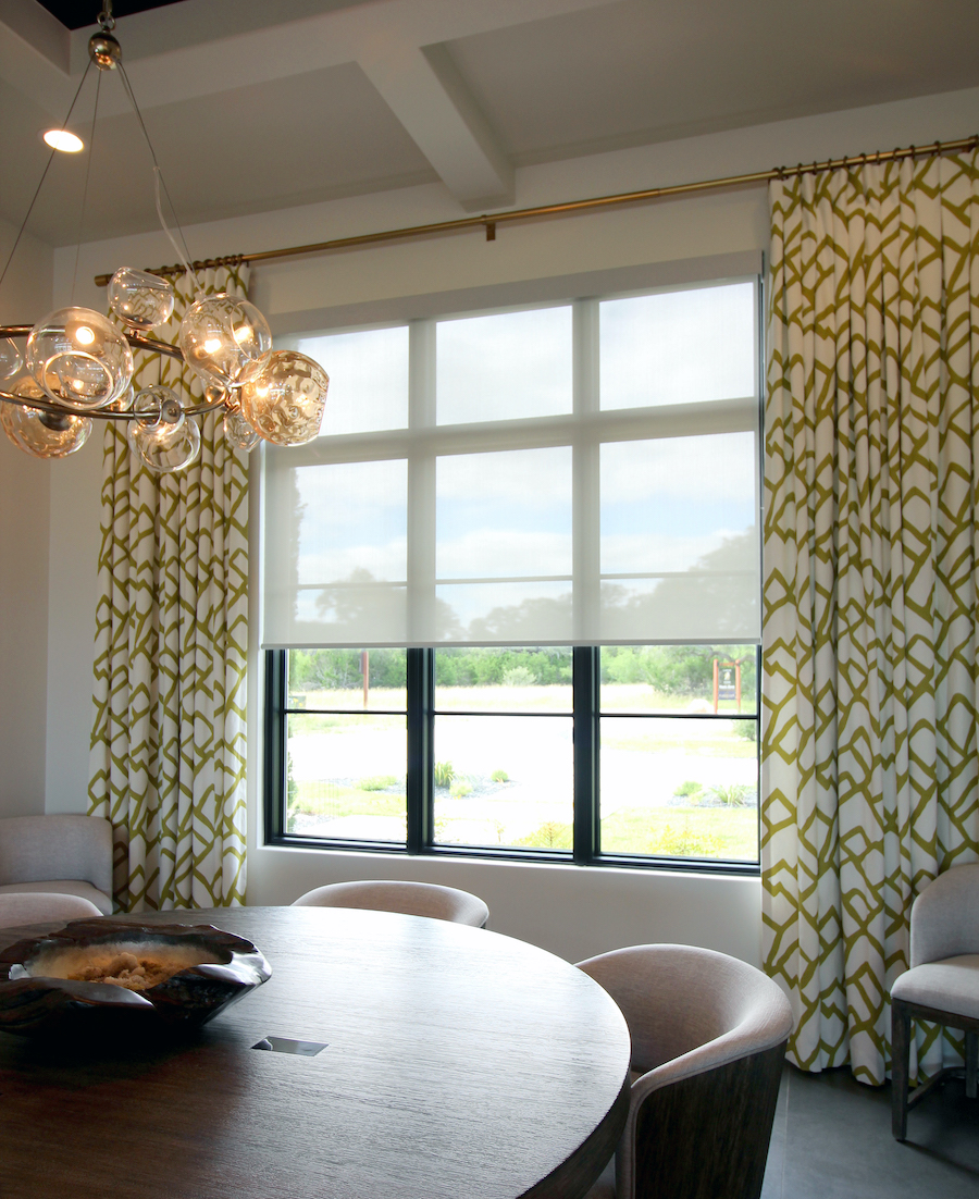 san antonio dining room with roller shade and patterned green draperies