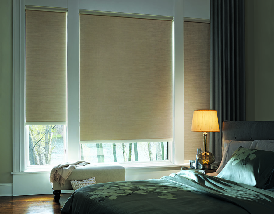 bedroom with designer roller shades