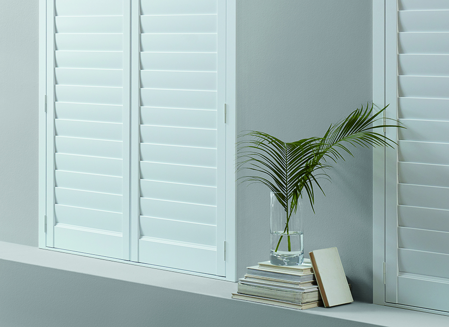 white interior shutters in bedroom