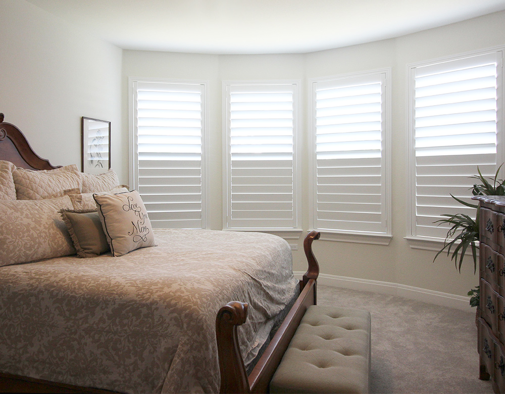 white planation shutters covering bedroom bay windows in San Antonio TX