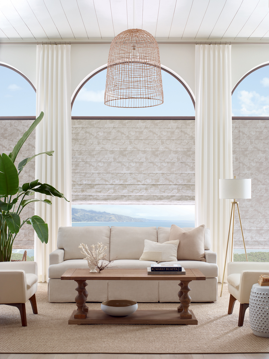 beige roman shades with basket light in living room with arched window in San Antonio