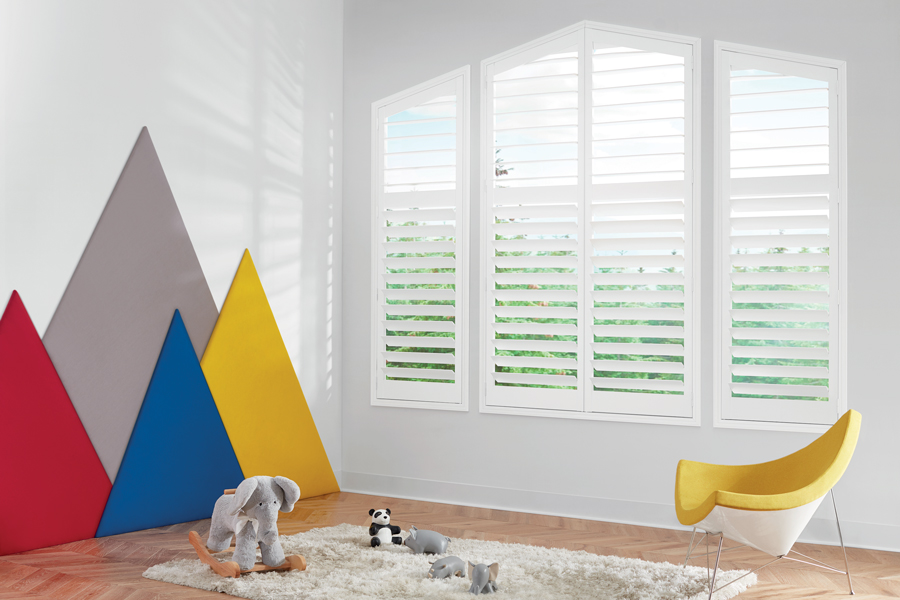 white shutters on angled windows in playroom