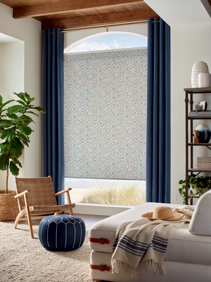 living room with curved top window and custom window treatments