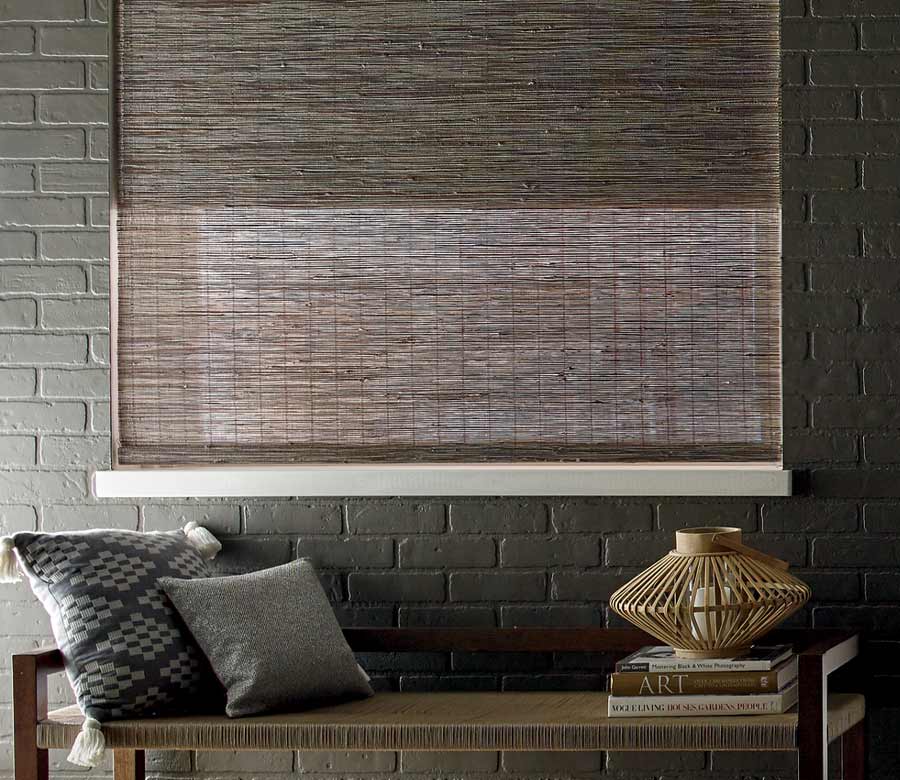 exposed brick wall painted black with coordinating dark brown window treatments in San Antonio, TX