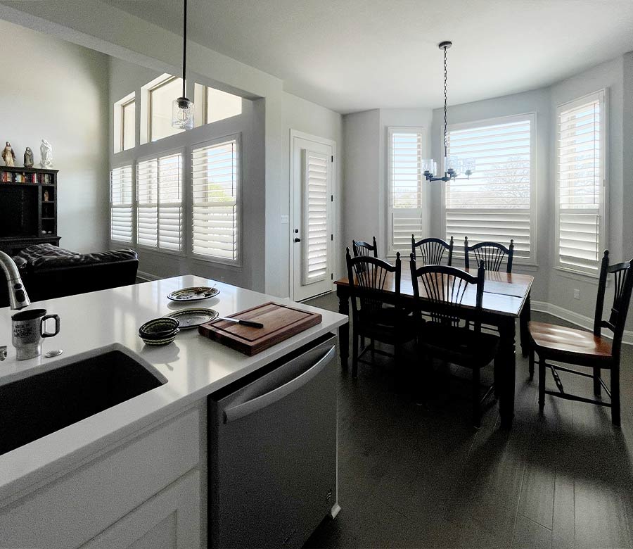 bay window shutters in dining room and patio door with custom white shutters