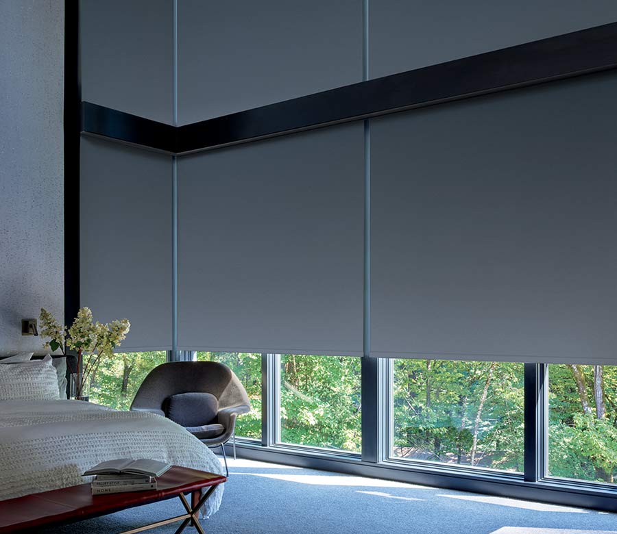 Large corner windows with floor to ceiling roller shades for room darkening San Antonio, TX