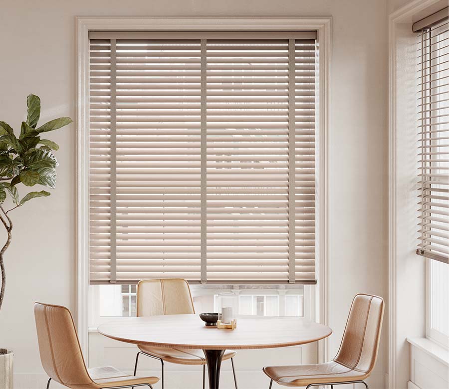 modern seating and dining area with large windows facing out into the city