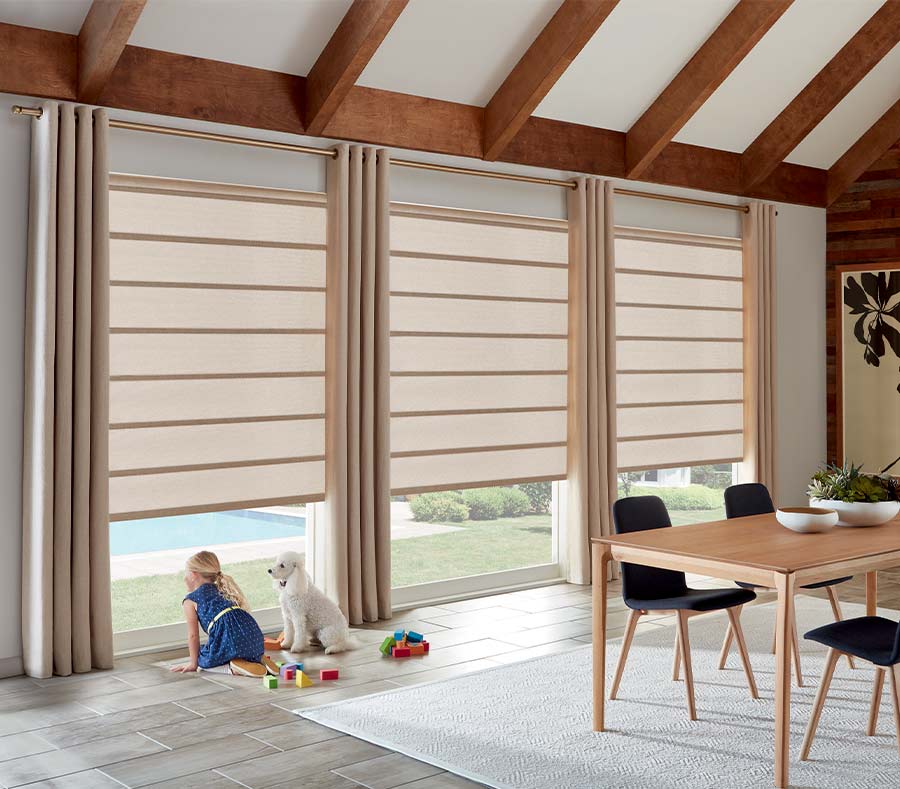 dining room with large windows and drapery panels floor to ceiling