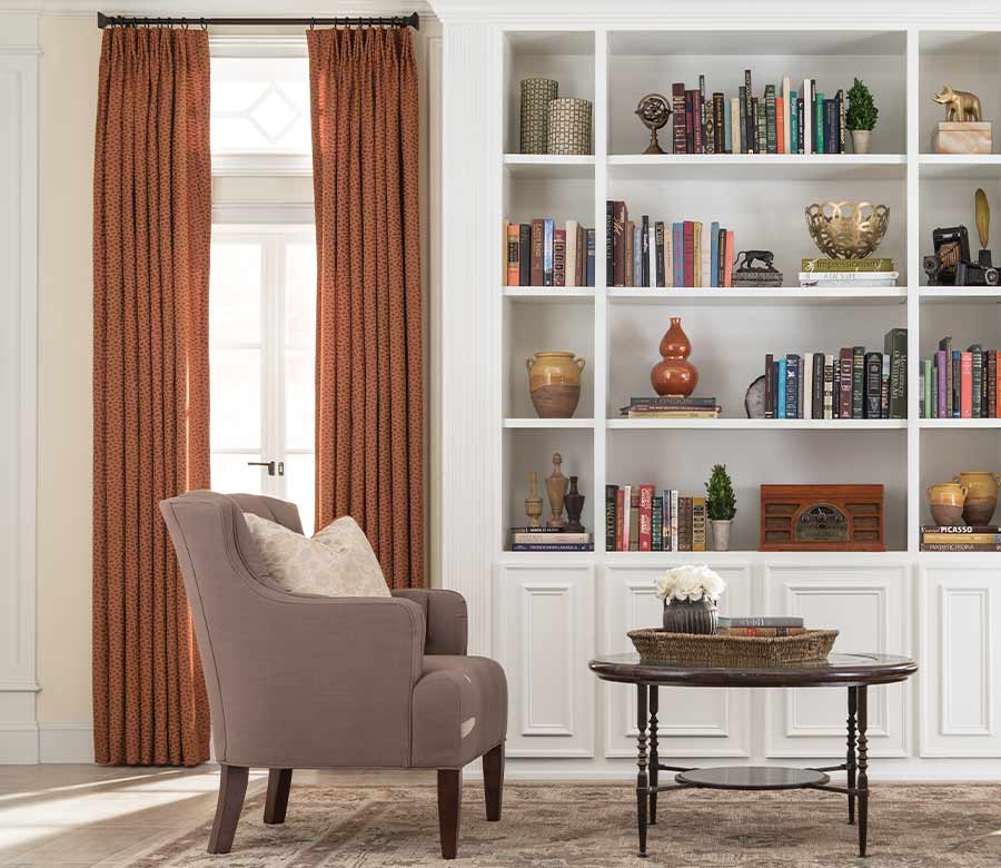 custom window treatments as burnt orange curtain panels in home library