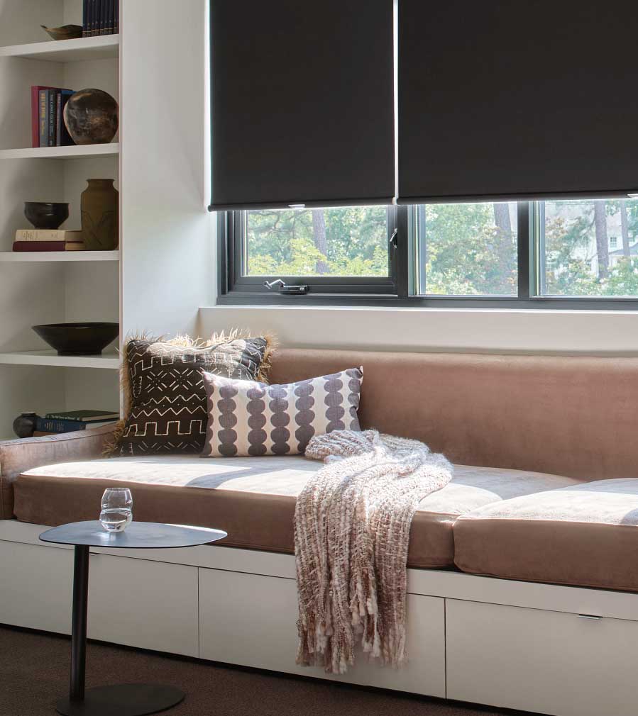 window seat with black designer roller shades