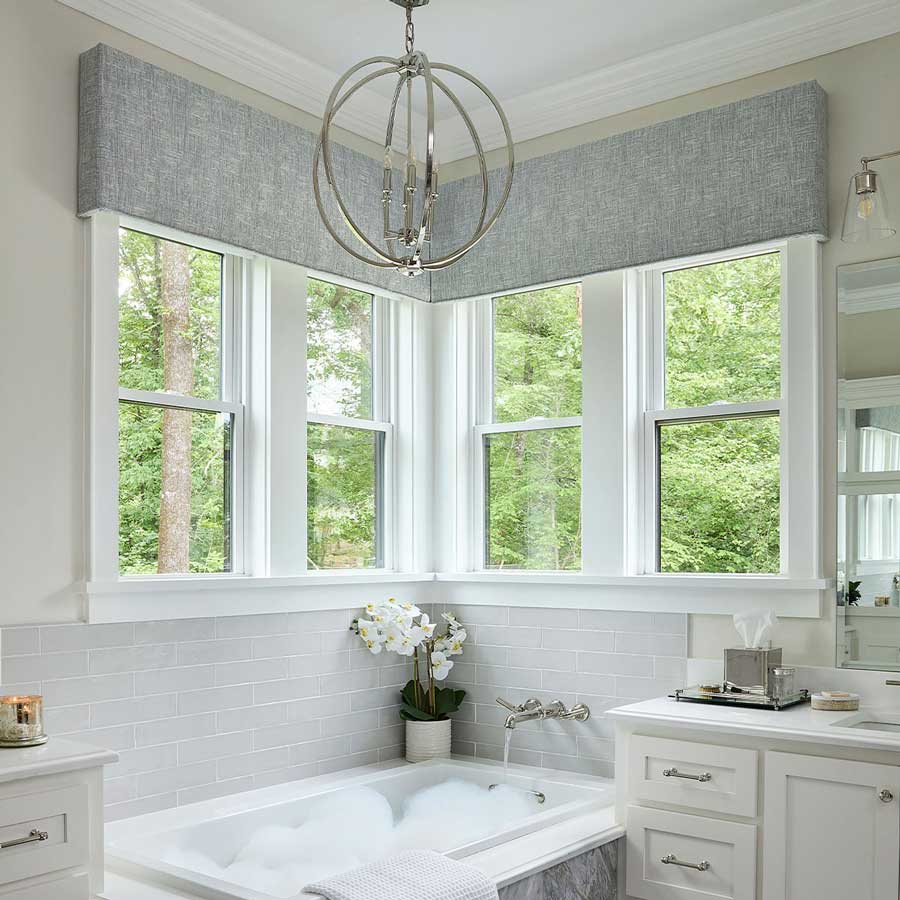 bathroom with window that have custom cornices