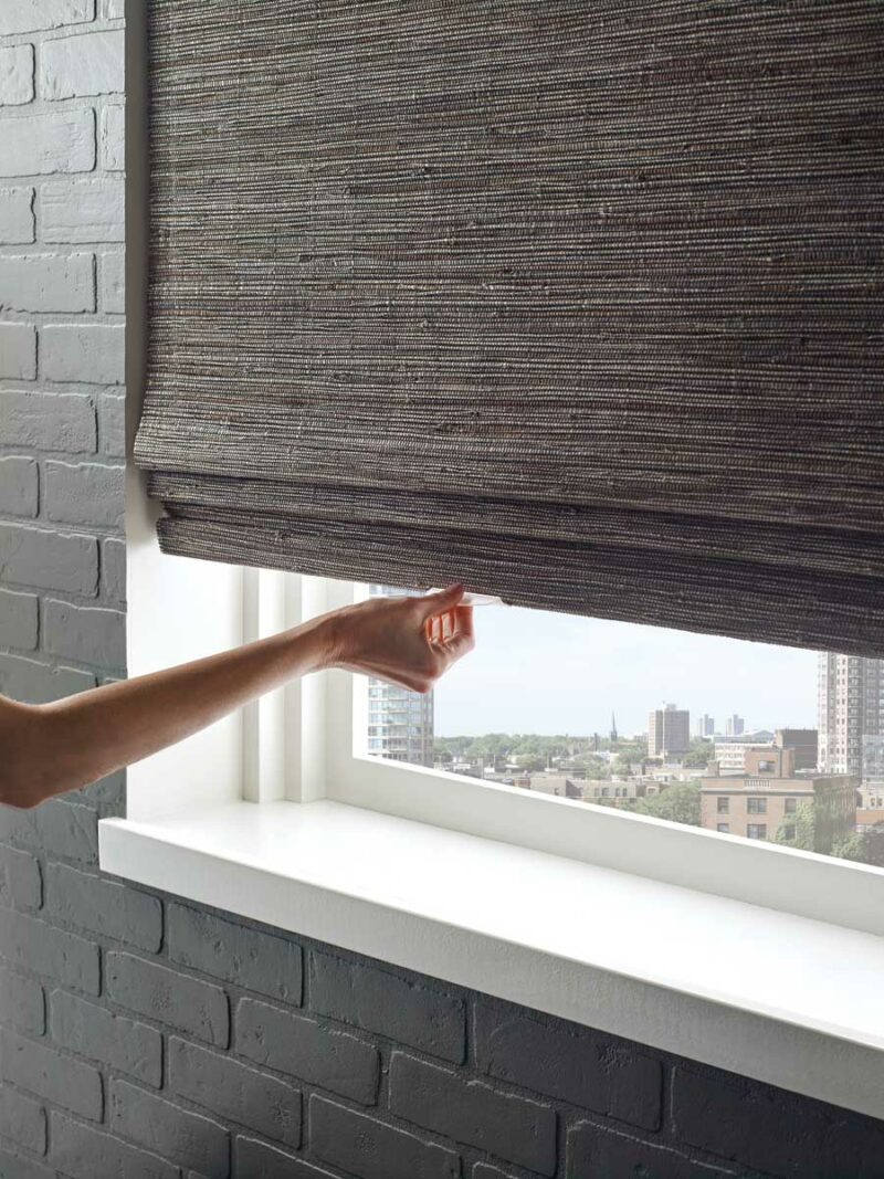 blackout roman shades in bedroom with cordless operation
