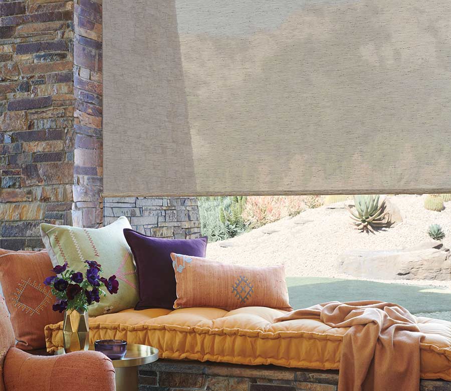 brown designer roller shades at window seat