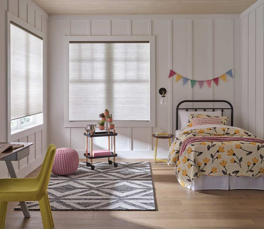 applause-honeycomb-cellular-shades-hunter-douglas-window-fashions-of-texas children bedroom with white honeycomb cellular window shades and colorful bedding