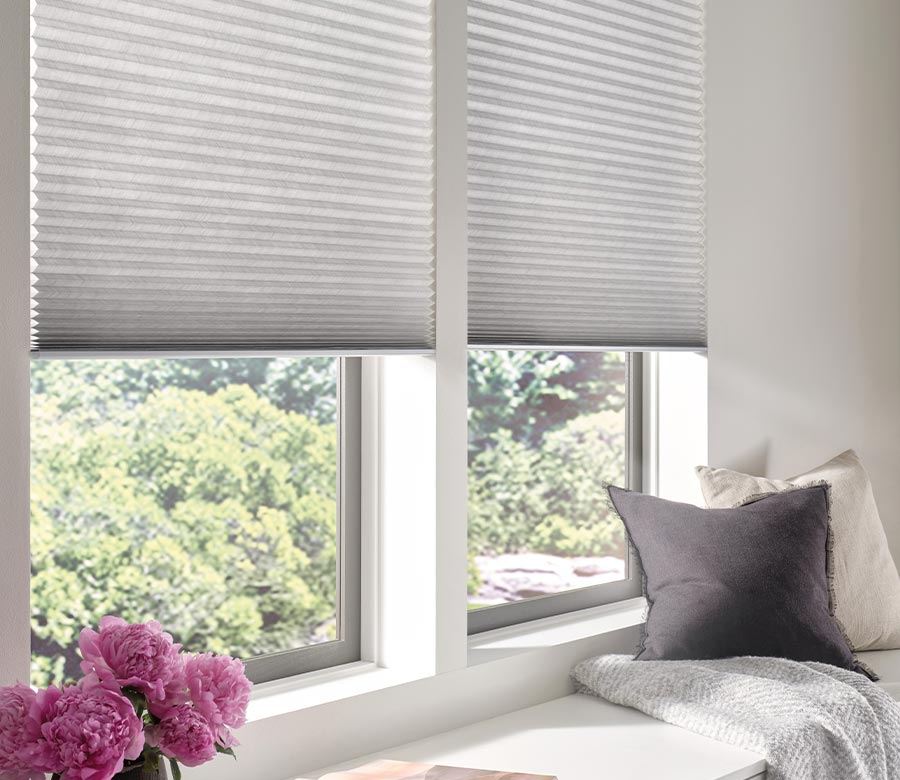 applause-honeycomb-side-by-side-cellular-shades-hunter-douglas-window-fashions-of-texas window seat with white honeycomb window shades in bedroom
