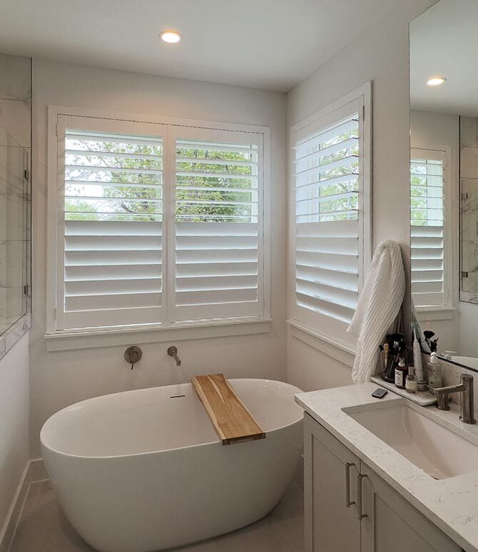 white shutters in bathroom with tub