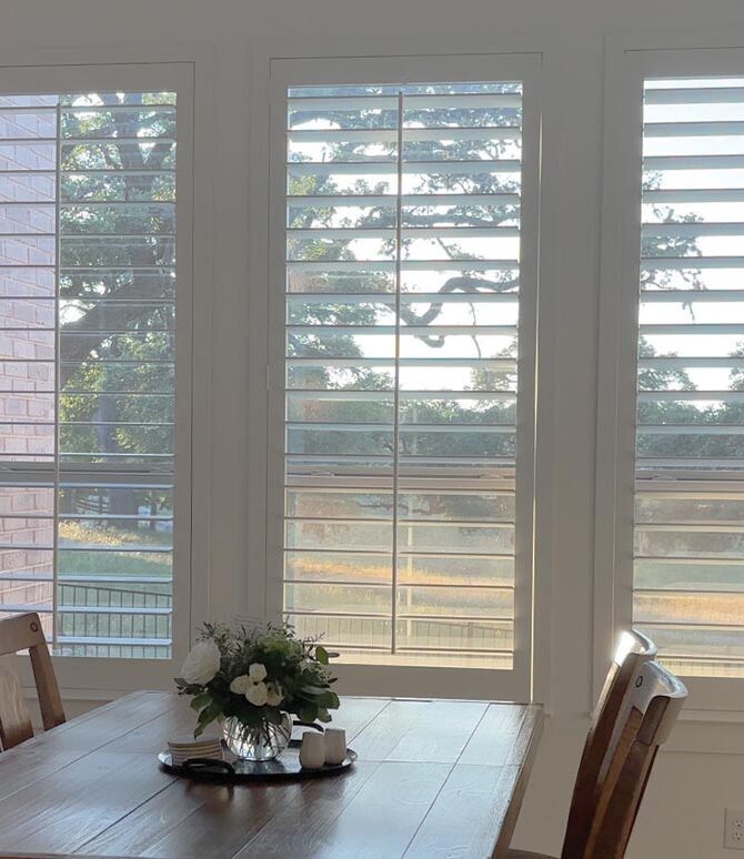 dining table area with white shutters